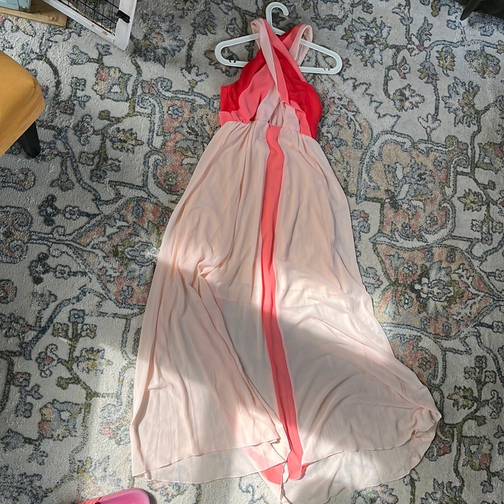 Pink venus cross in front with peekaboo triangle under bust.